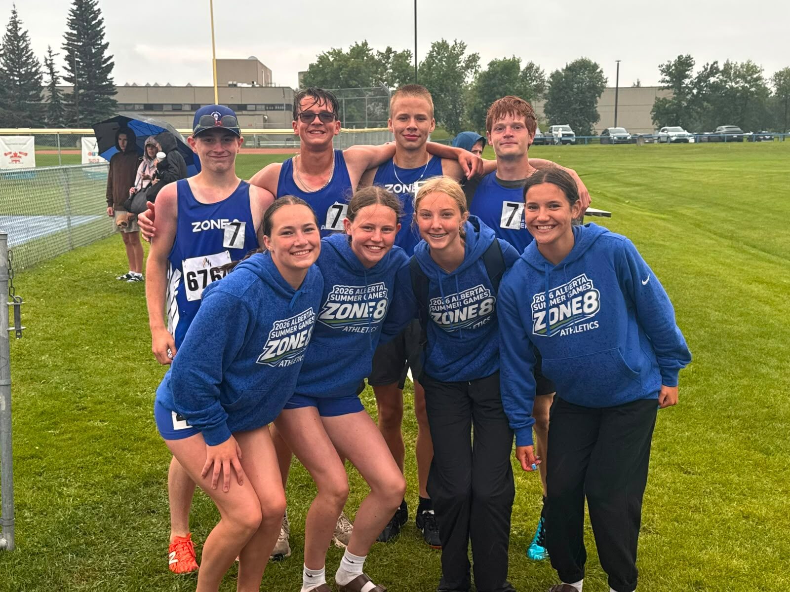 Zone 8 relay athletes in team hoodies after their races